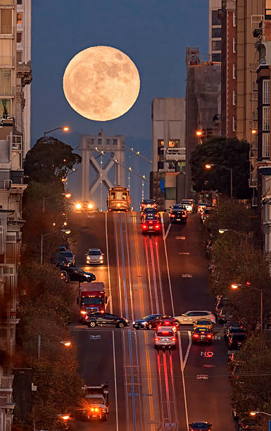 Supermoon at California Street Composition, San Francisco San Francisco California street, bay bridge and supermoon on the background. full moon photos stock pictures, royalty-free photos & images