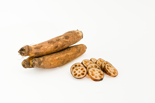 Lotus root - whole and chopped - on a white background