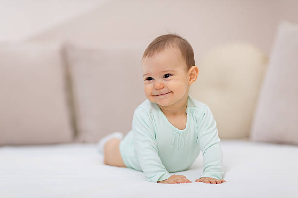 istock Baby girl on white bed 626915930