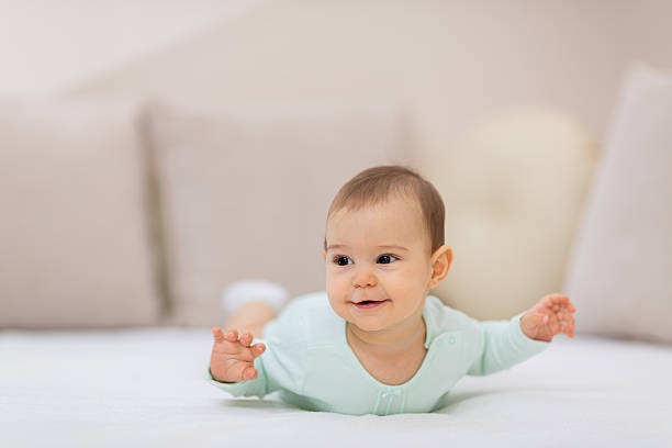 istock Baby girl on white bed 626915956