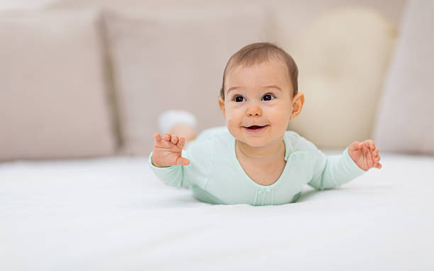 istock Baby girl on white bed 626915980