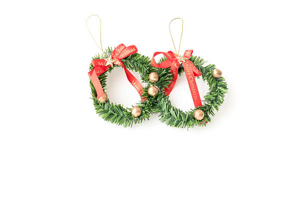 istock Green christmas wreath with decorations isolated on white background 626916888