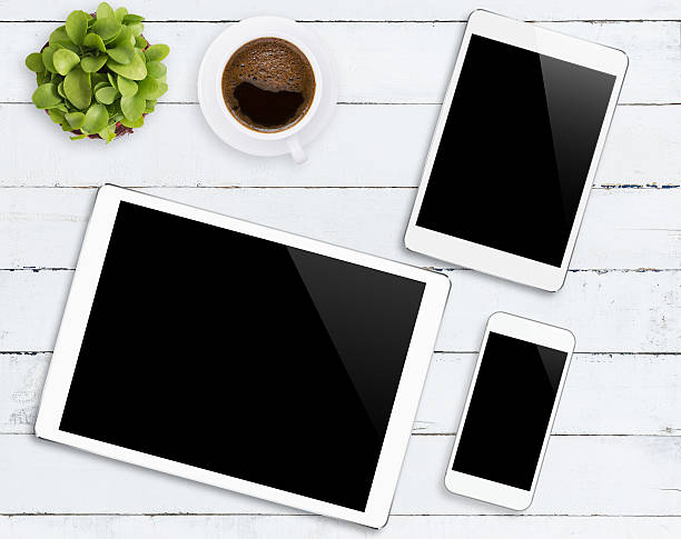 communicator device phone and tablet white color tone on wood table, mockup modern phone and digital tablet