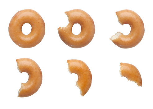 Sequence of bites taken off a donut isolated on white background