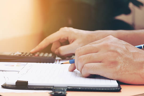 istock Man hand is holding pencil thinking about savings finance 626943924