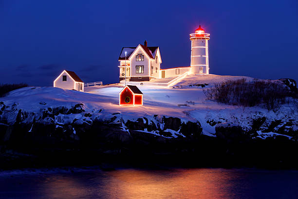 Christmas Lights on the Nubble Light Cape Neddick Lighthouse or Nubble Light is a lighthouse in Cape Neddick, York, Maine. Cape Neddick Light Station was dedicated by the U.S. Lighthouse Service and put into use in 1879. It is still in use today. lighthouse maine new england coastline stock pictures, royalty-free photos & images