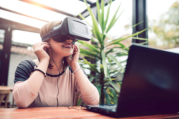 istock Young Woman Having Fun with Virtual Reality Simulator with Headphones 626944962