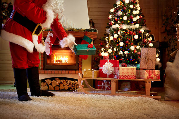 istock Santa Claus leaves a gift under the Christmas tree 626945276