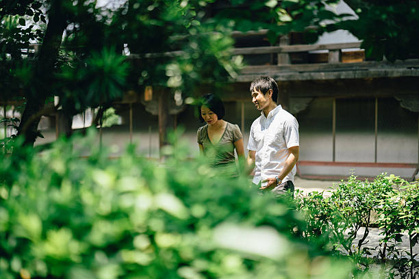 istock Cheerful japanese couple at the temple, front view 626946126