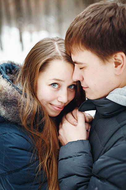 istock Couple in love having fun in winter forest 626954314