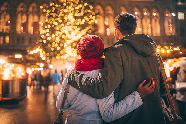 Romance on Christmas market Photo of a young couple enjoy the decoration on Christmas Market, during Christmas Holidays christmas market photos stock pictures, royalty-free photos & images