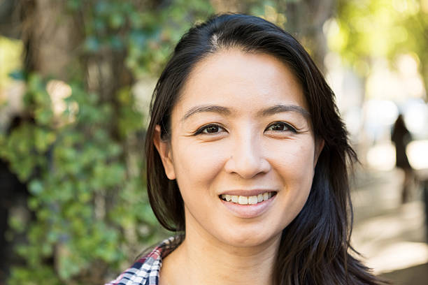 istock Smiling asian woman looking at the camera 626955262