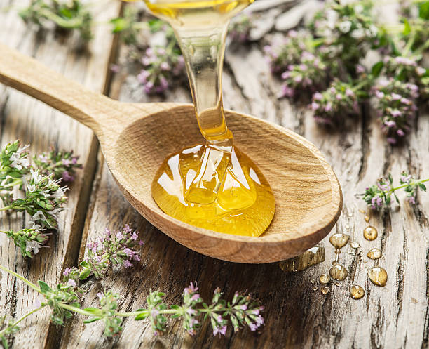 istock Herbal honey pouring into the wooden spoon. 626958920