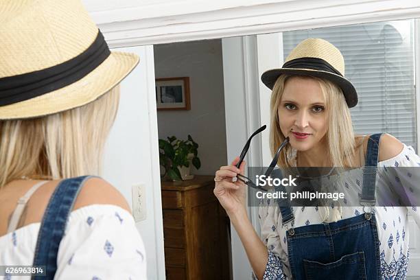 Beautiful Blond Woman Posing With Summer Hat In The Mirror Stock Photo - Download Image Now