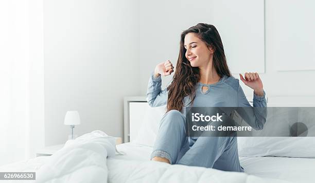 Girl Waking Up And Stretching Stock Photo - Download Image Now - Waking up, Women, Bed - Furniture