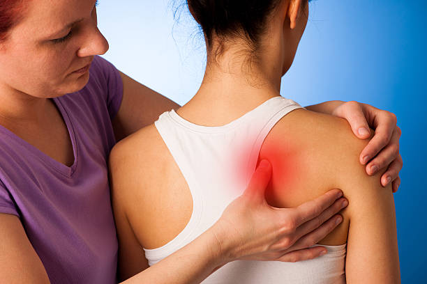 istock physio therapist helping Woman having pain in her back 626966910