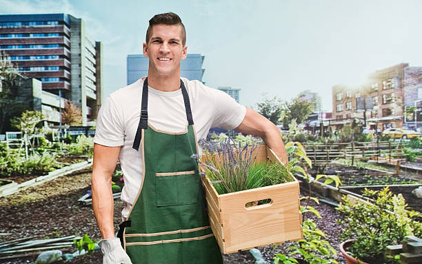 Smiling gardener standing in garden
