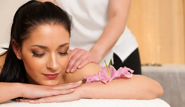 Beautifulyoung woman having a rejuvenating massage in a wellness studio - spa