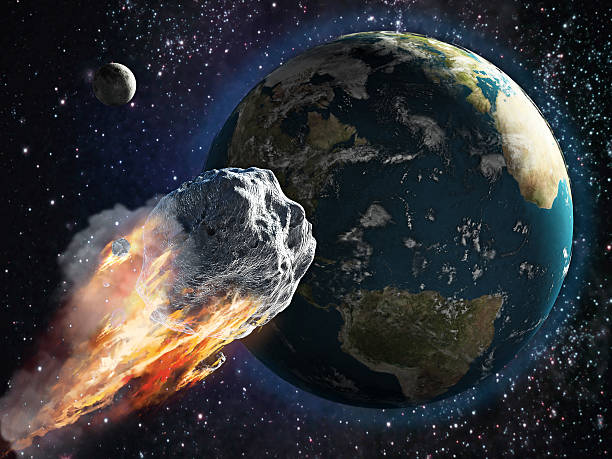 Burning asteroid moving through the Earth stock photo