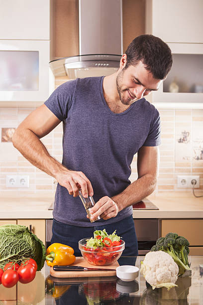istock Young man preparing food at home 626995750