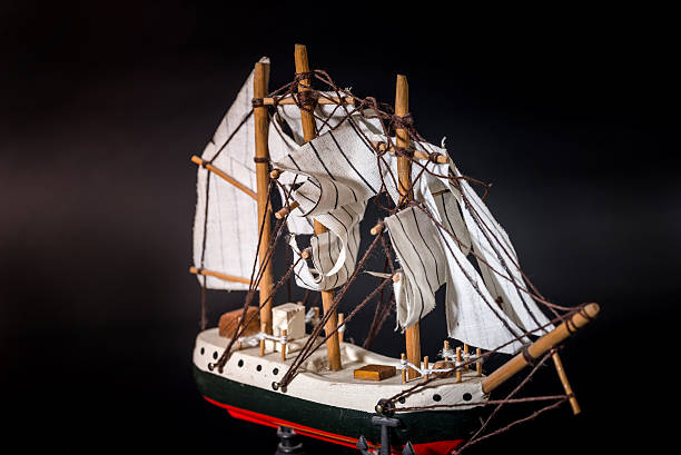 istock Wooden ship toy model, isolated on black background 626995770