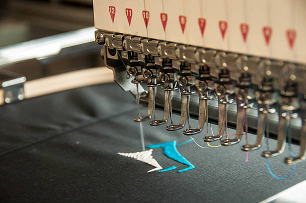 Embroidery machine stiching Embroidery machine at work machinery stock pictures, royalty-free photos & images