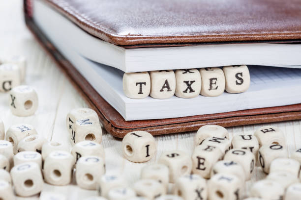istock Word TAXES on old wooden table. 626996296