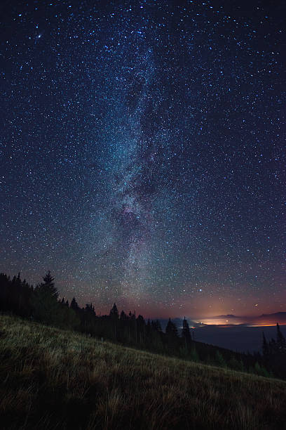 istock Night sky with Milky Way over the forest 626997330