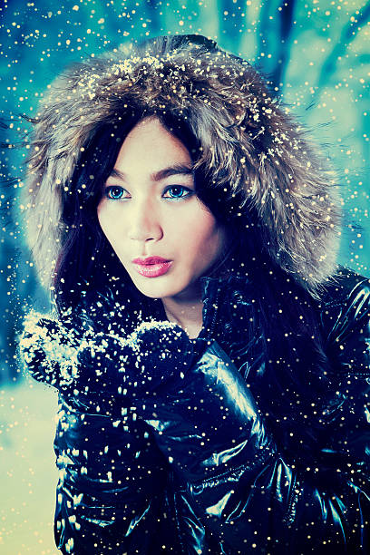 istock Sweet girl in fur jacket playing snow 626998076