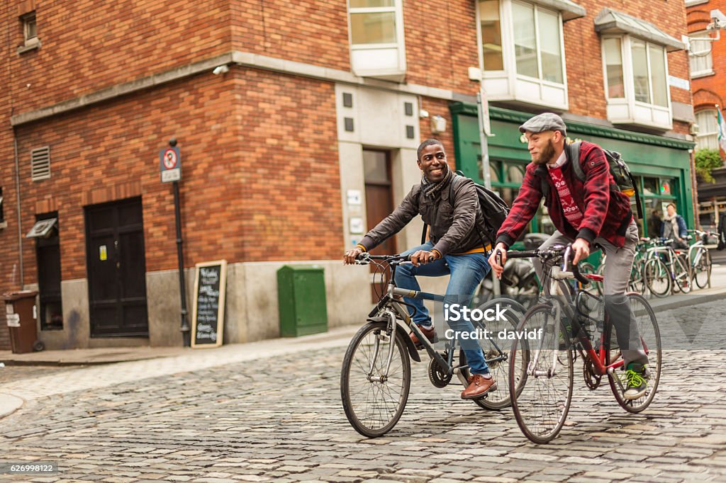 Mixed Race Gay Couple With Bicycles in the City Mixed race gay men with bicycles in the city in the Temple Bar district of Dublin, Ireland Dublin - Republic of Ireland Stock Photo