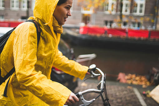 Woman riding a bike through Amsterdam