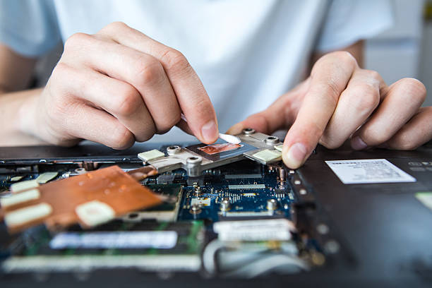 istock man repairing a computer. laptop clean thermal 626999016