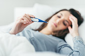 Woman measuring her temperature