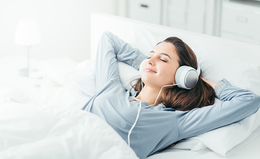 Beautiful emotional woman listening to music