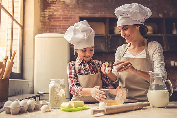 istock Mom and daughter baking 627001644