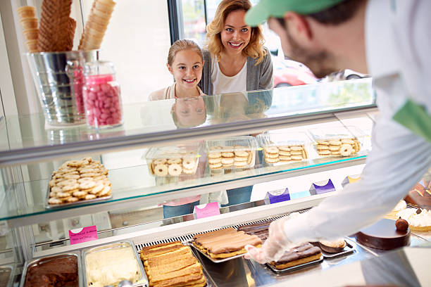 istock Mother with daughter in pastry shop 627002162