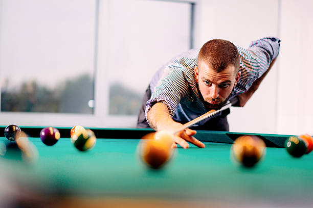 istock Portrait of billiard player aiming 627002480