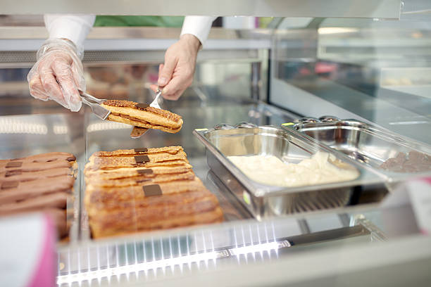 istock Close up of vendor's hands taking out  biscuit cake 627003382