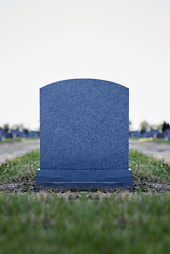 Shot of a gravestone in a cemetery