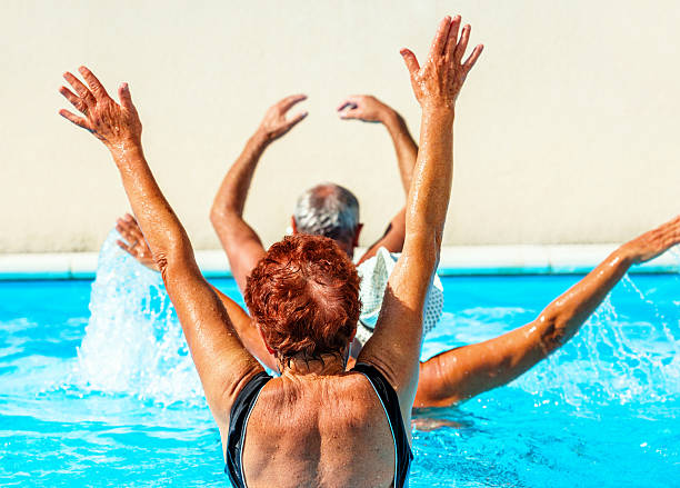 istock Active seniors getting a workout at the swimming pool 627009252