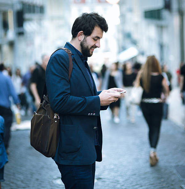 istock Businessman using smartphone on the european street 627011394