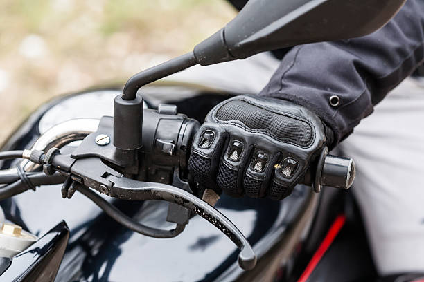 istock Biker sitting on motorcycle, close-up view on hands on handlebar 627011828