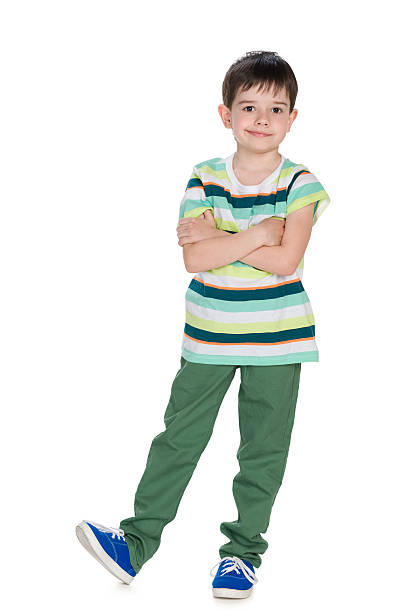 istock Little boy in a green striped shirt looks forward 627013132