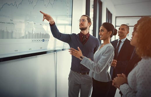 Shot of two young businespeople giving a presentation in the boardroom