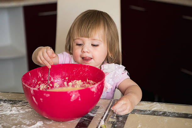 istock Little girl mixing dough 627013974