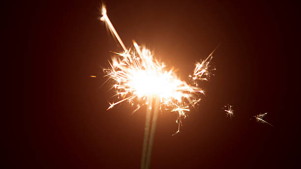 istock shiny bright sparklers with red background 627014086