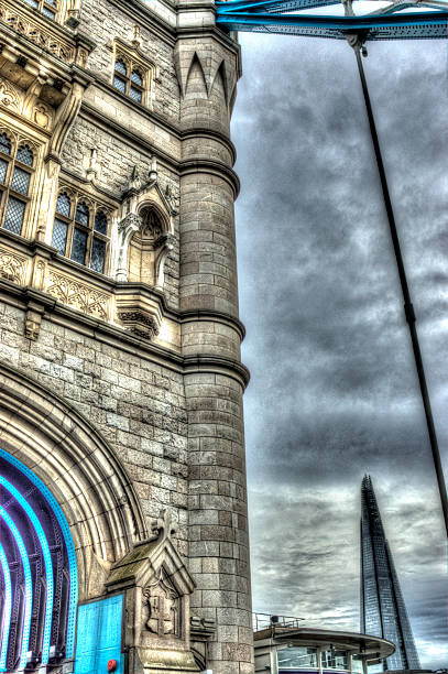 Tower Bridge View of Tower bridge viewed on a bright sunny spring day showing a close up of a single tower on the south side of the river. the shard close up stock pictures, royalty-free photos & images
