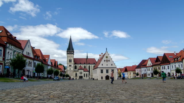 Time lapse of people and clouds in historic center of Bardejov in Slovakia. Zoom in on church