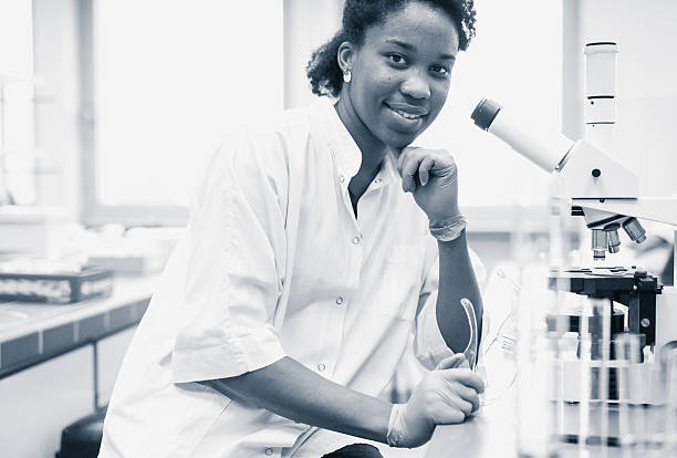 istock Portrait of a Scientist Beside the  Microscope 627023662