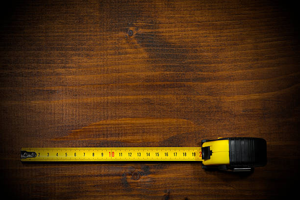 Tape Measure on a Wooden Work Table stock photo